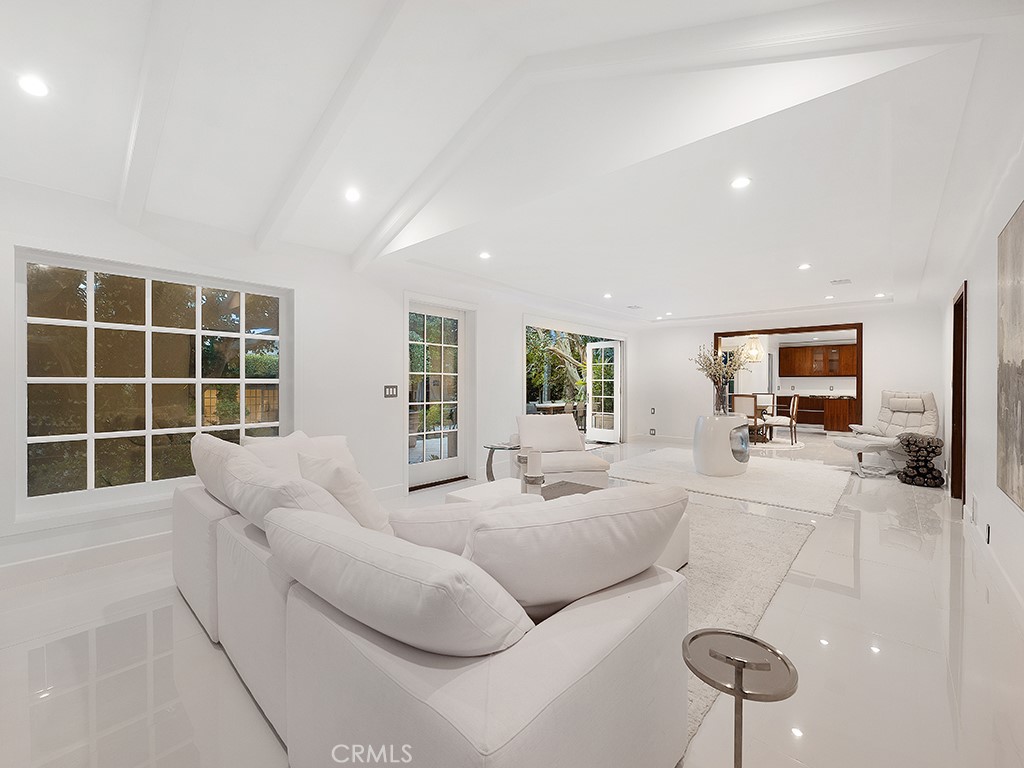726 Foothill Road Beverly Hills, CA 90210 - Photo 16 of 59 a living room with furniture windows and a flat screen tv