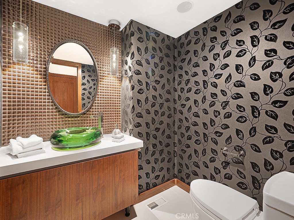 726 Foothill Road Beverly Hills, CA 90210 - Photo 21 of 59 a bathroom with a sink mirror and toilet