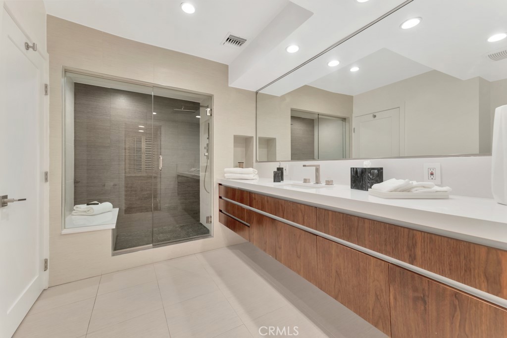 726 Foothill Road Beverly Hills, CA 90210 - Photo 25 of 59 a bathroom with a double vanity sink toilet and shower