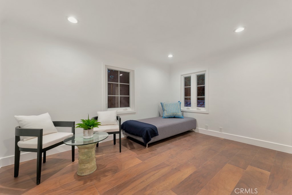 726 Foothill Road Beverly Hills, CA 90210 - Photo 29 of 59 a living room with furniture and a potted plant
