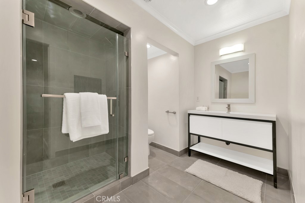 726 Foothill Road Beverly Hills, CA 90210 - Photo 30 of 59 a bathroom with a sink and a mirror