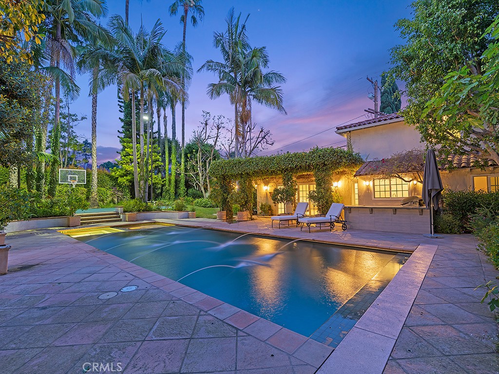726 Foothill Road Beverly Hills, CA 90210 - Photo 3 of 59 a view of a swimming pool with an outdoor space and seating area
