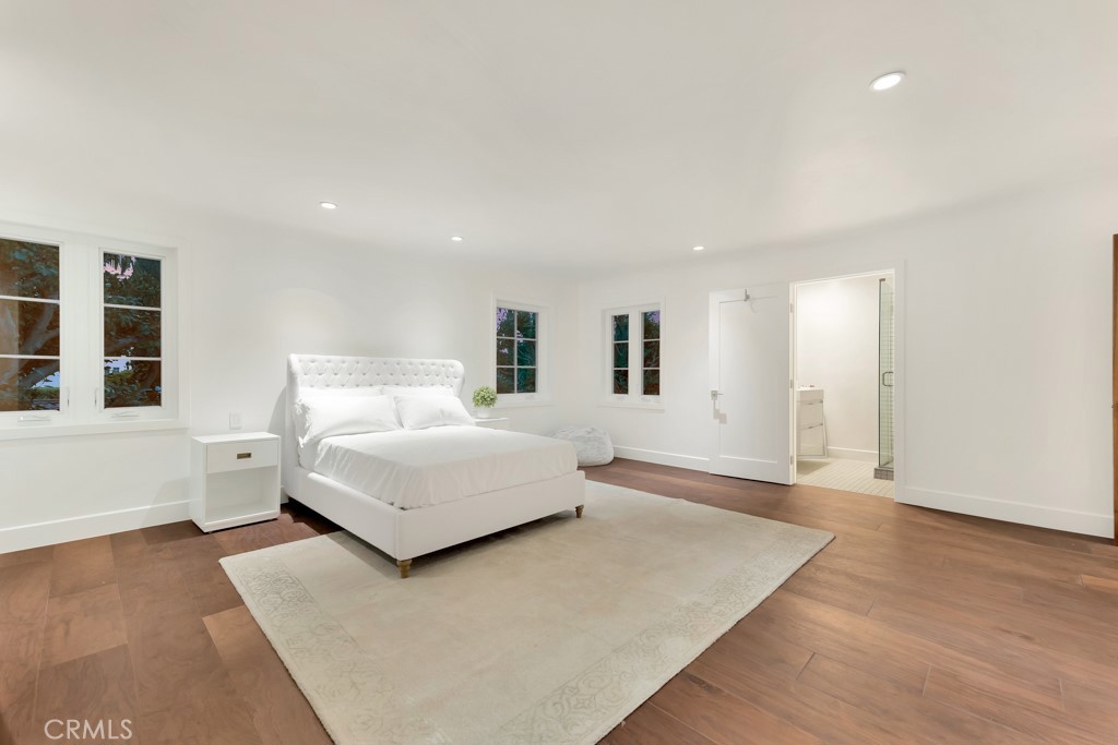 726 Foothill Road Beverly Hills, CA 90210 - Photo 32 of 59 a bedroom with a large bed and wooden floor