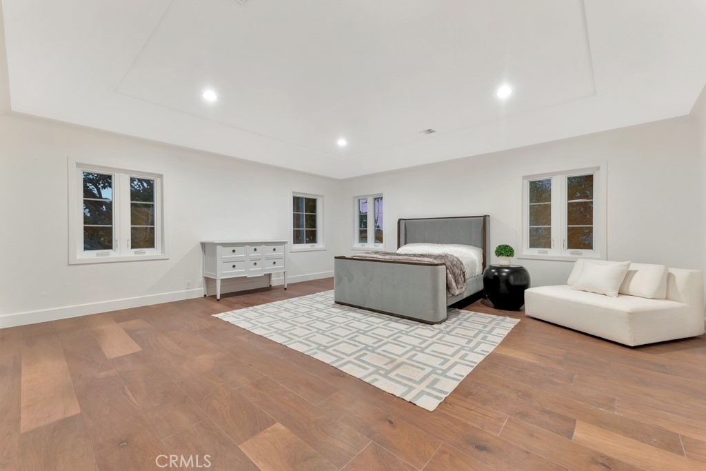 726 Foothill Road Beverly Hills, CA 90210 - Photo 33 of 59 a spacious bedroom with a large bed a couch and a window