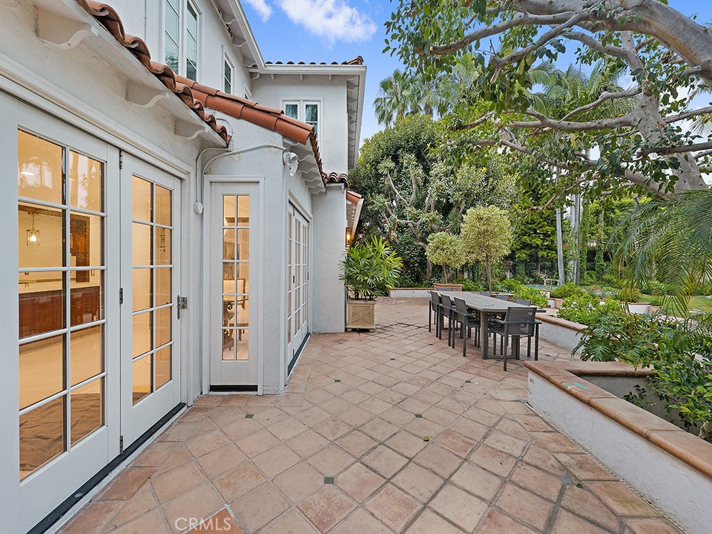 726 Foothill Road Beverly Hills, CA 90210 - Photo 46 of 59 a view of a patio with table and chairs and potted plants