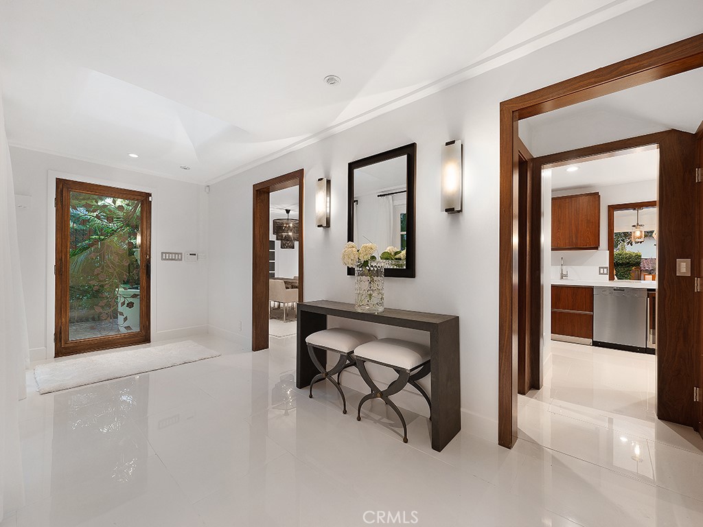 726 Foothill Road Beverly Hills, CA 90210 - Photo 9 of 59 a view of a hallway with wooden floor and a living room