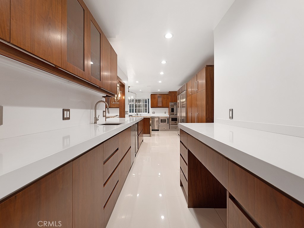 726 Foothill Road Beverly Hills, CA 90210 - Photo 10 of 59 a large kitchen with stainless steel appliances