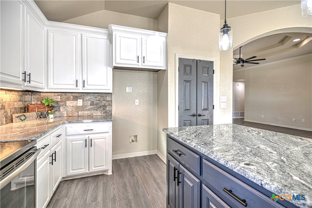 3106 Pitchfork Circle Belton, TX 76513 - Photo 13 of 45 a kitchen with granite countertop a sink stainless steel appliances and cabinets