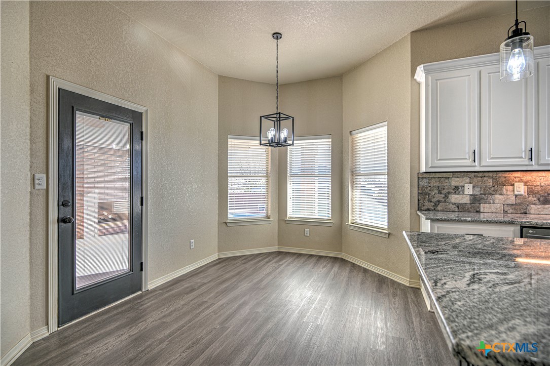 3106 Pitchfork Circle Belton, TX 76513 - Photo 16 of 45 a view of an empty room with window and wooden floor
