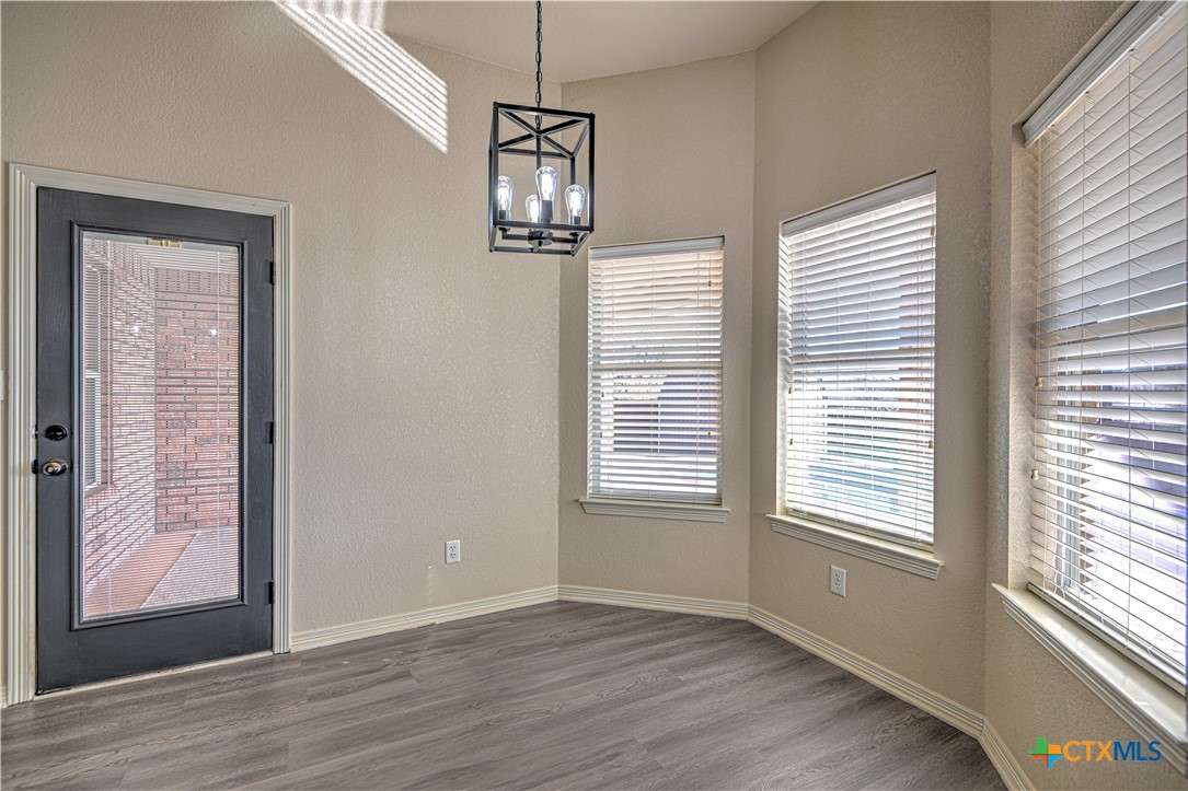 3106 Pitchfork Circle Belton, TX 76513 - Photo 17 of 45 a view of an empty room with wooden floor and a window