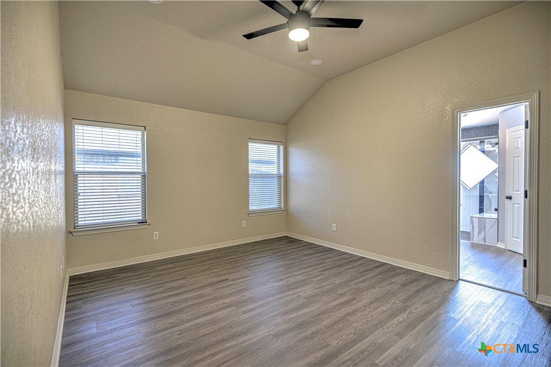 3106 Pitchfork Circle Belton, TX 76513 - Photo 18 of 45 an empty room with wooden floor and windows