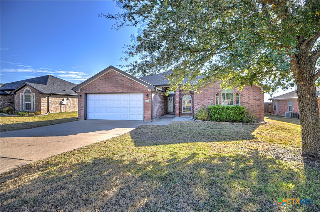 3106 Pitchfork Circle Belton, TX 76513 - Photo 2 of 45 a front view of a house with a yard and garage
