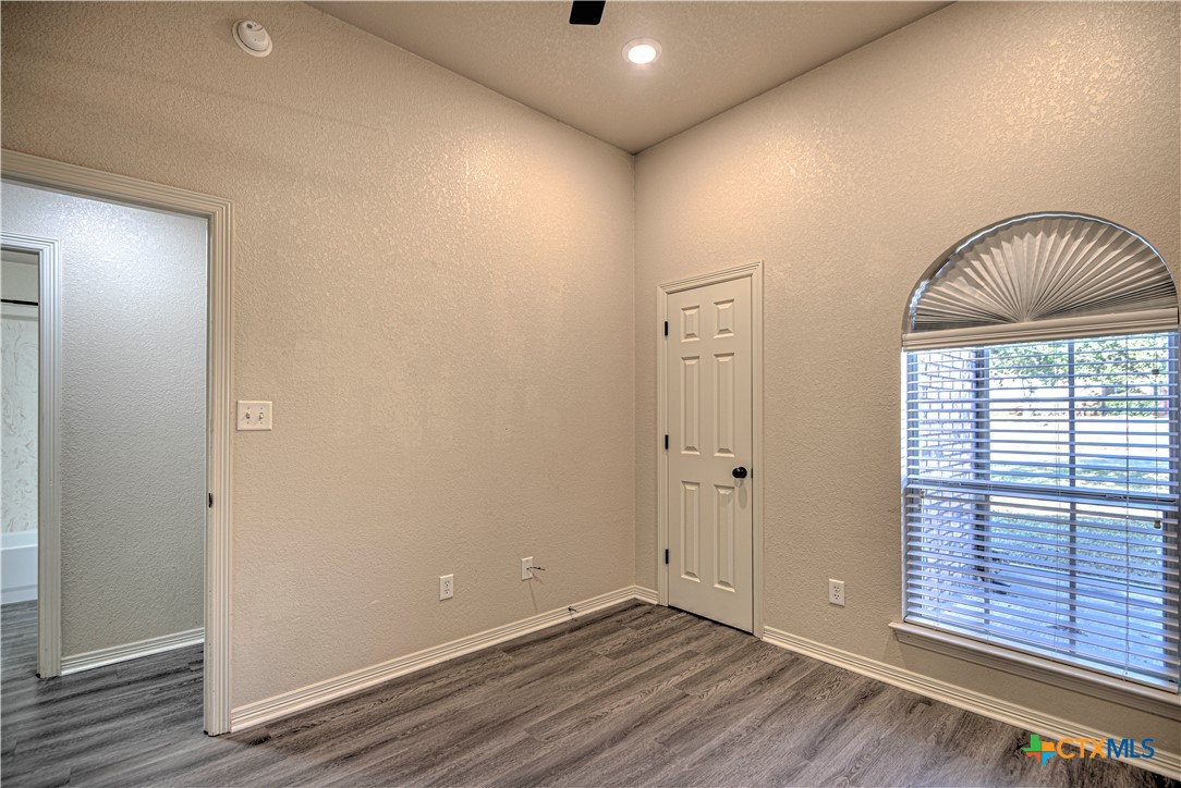 3106 Pitchfork Circle Belton, TX 76513 - Photo 27 of 45 a view of an empty room with wooden floor and a window