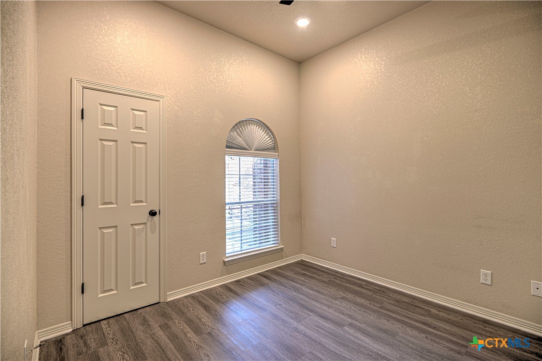 3106 Pitchfork Circle Belton, TX 76513 - Photo 28 of 45 an empty room with wooden floor and windows