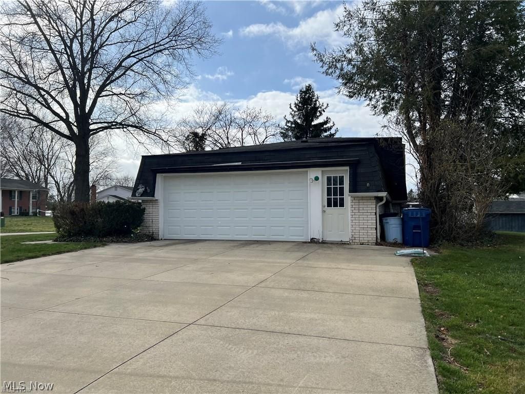 1580 Reed Street Canal Fulton, OH 44614 - Photo 4 of 21 View of side load garage with large concrete driveway.