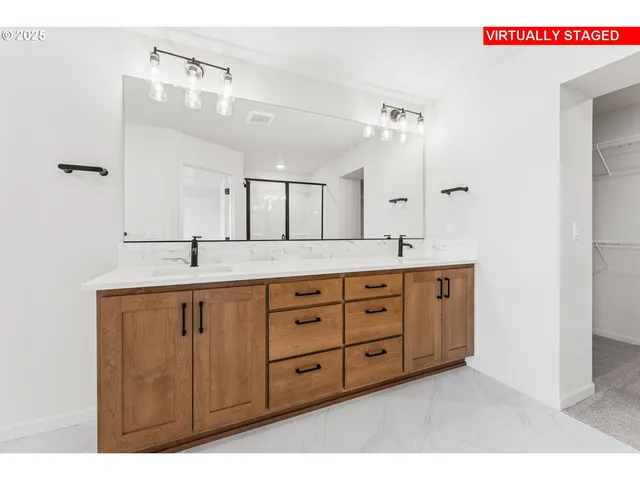 a spacious bathroom with double sink and a mirror