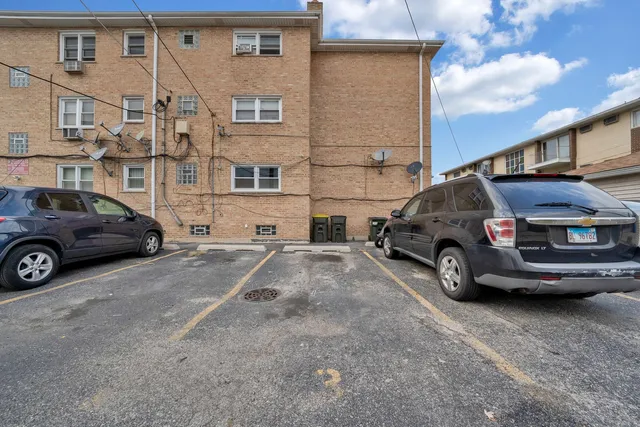 a view of cars parked in front of a house