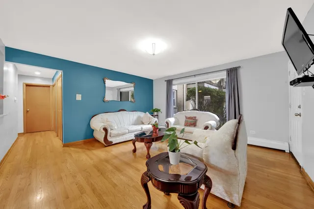 a bedroom with furniture and a wooden floor
