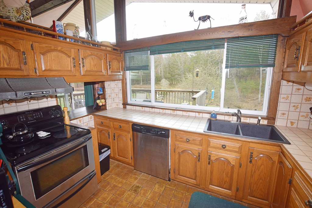 205 Monson Turnpike Road Petersham, MA 01366 - Photo 10 of 30 a kitchen with wooden cabinets stove and sink