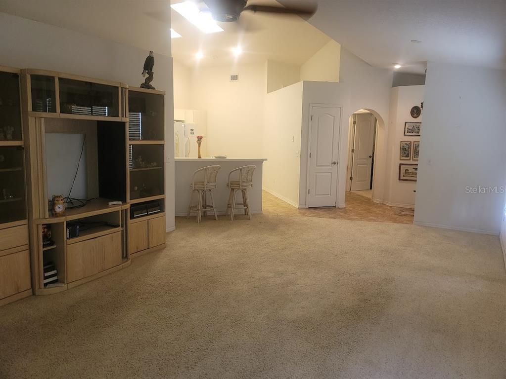 21544 Clubside Loop Lutz, FL 33549 - Photo 2 of 11 a view of an empty room with kitchen and windows