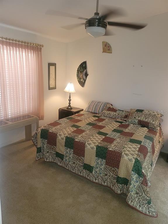 21544 Clubside Loop Lutz, FL 33549 - Photo 5 of 11 a bedroom with a bed and a chandelier