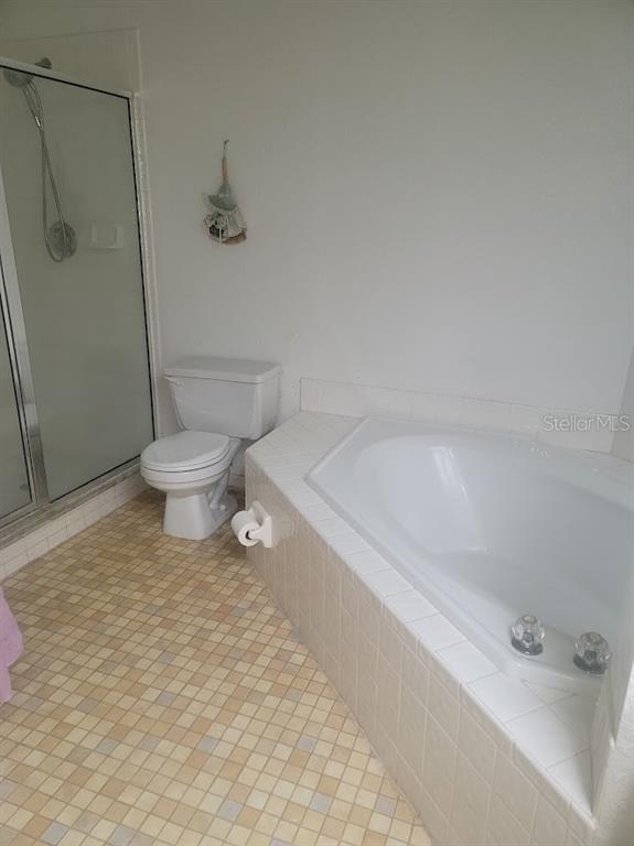 21544 Clubside Loop Lutz, FL 33549 - Photo 6 of 11 a bathroom with a toilet and a shower