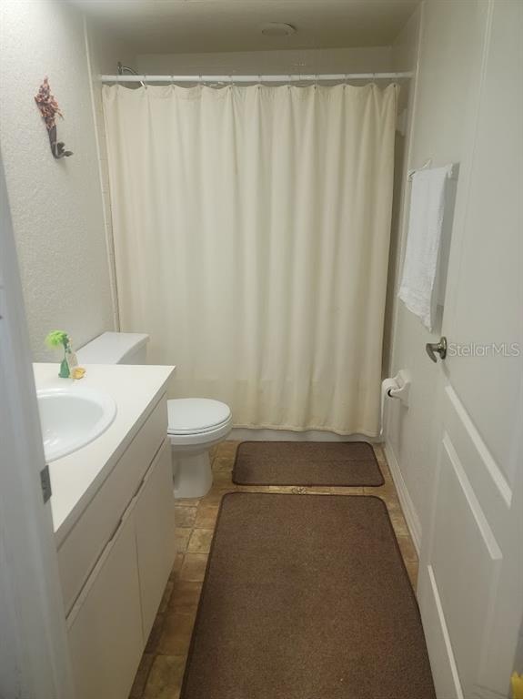 21544 Clubside Loop Lutz, FL 33549 - Photo 9 of 11 a bathroom with a sink a toilet and shower