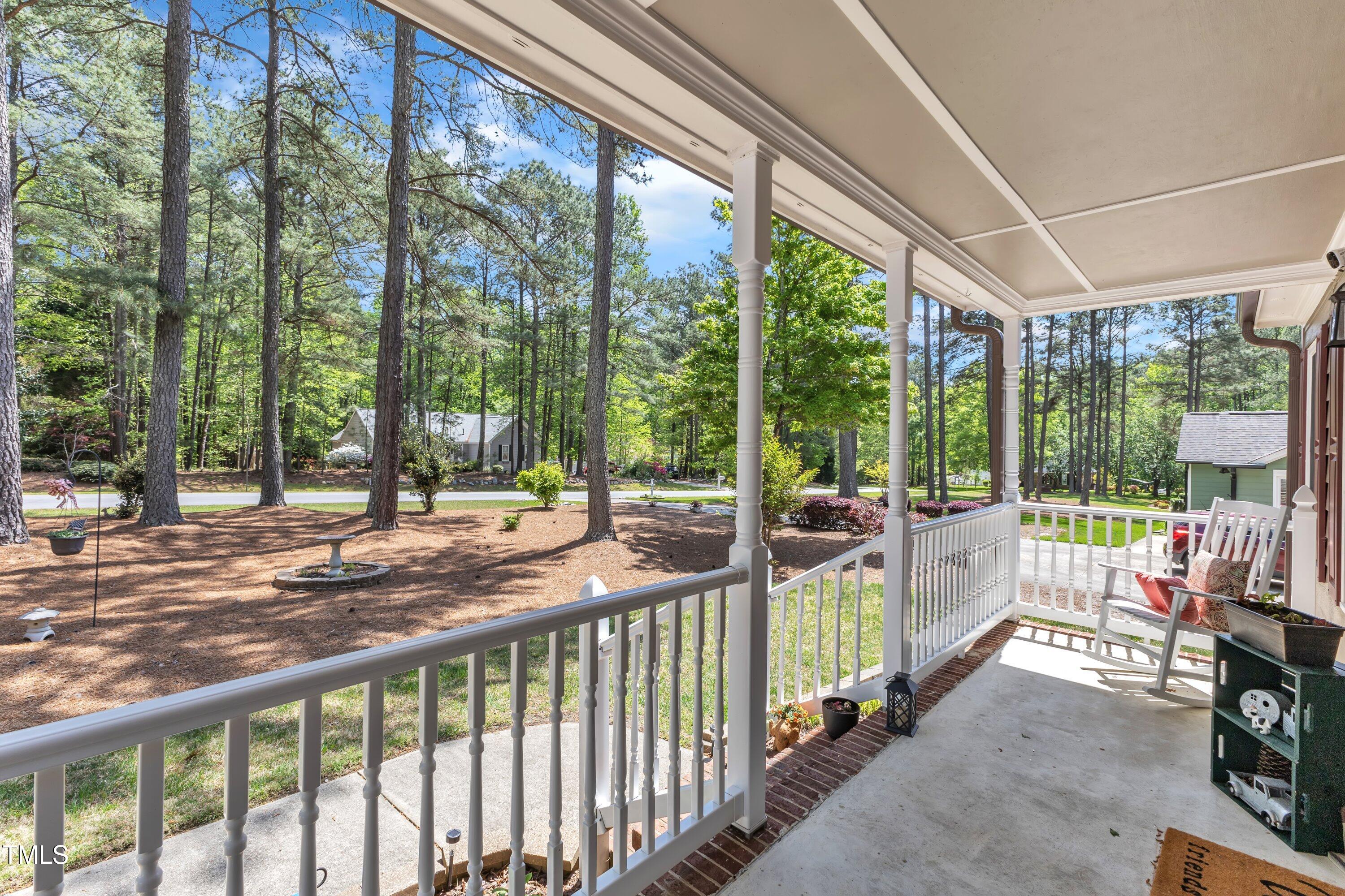 604 Young Forest Drive Wake Forest, NC 27587 - Photo 9 of 55 a view of a porch with chairs and floor to ceiling window