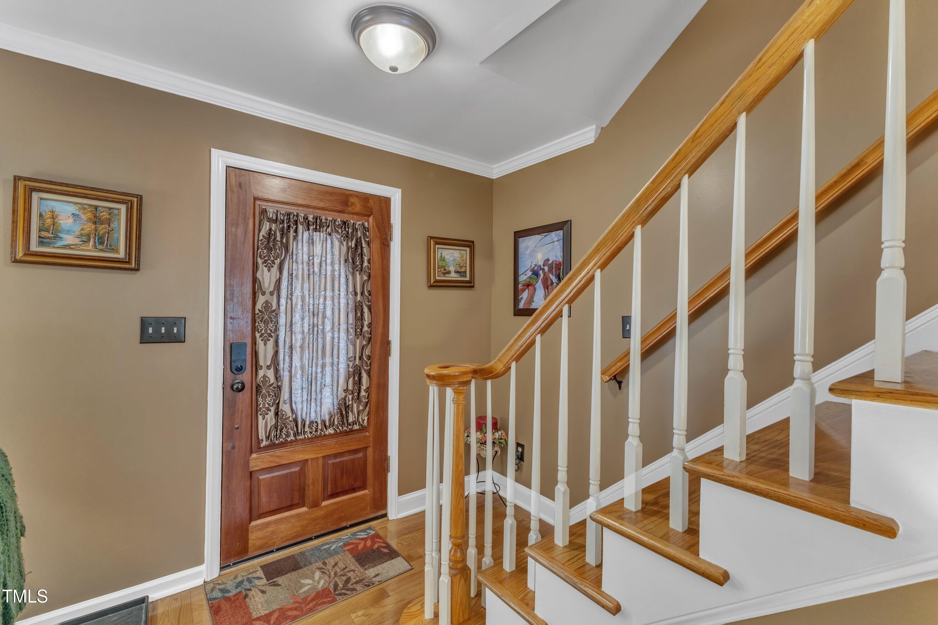 604 Young Forest Drive Wake Forest, NC 27587 - Photo 10 of 55 a view of staircase with lots of frames on wall and a window