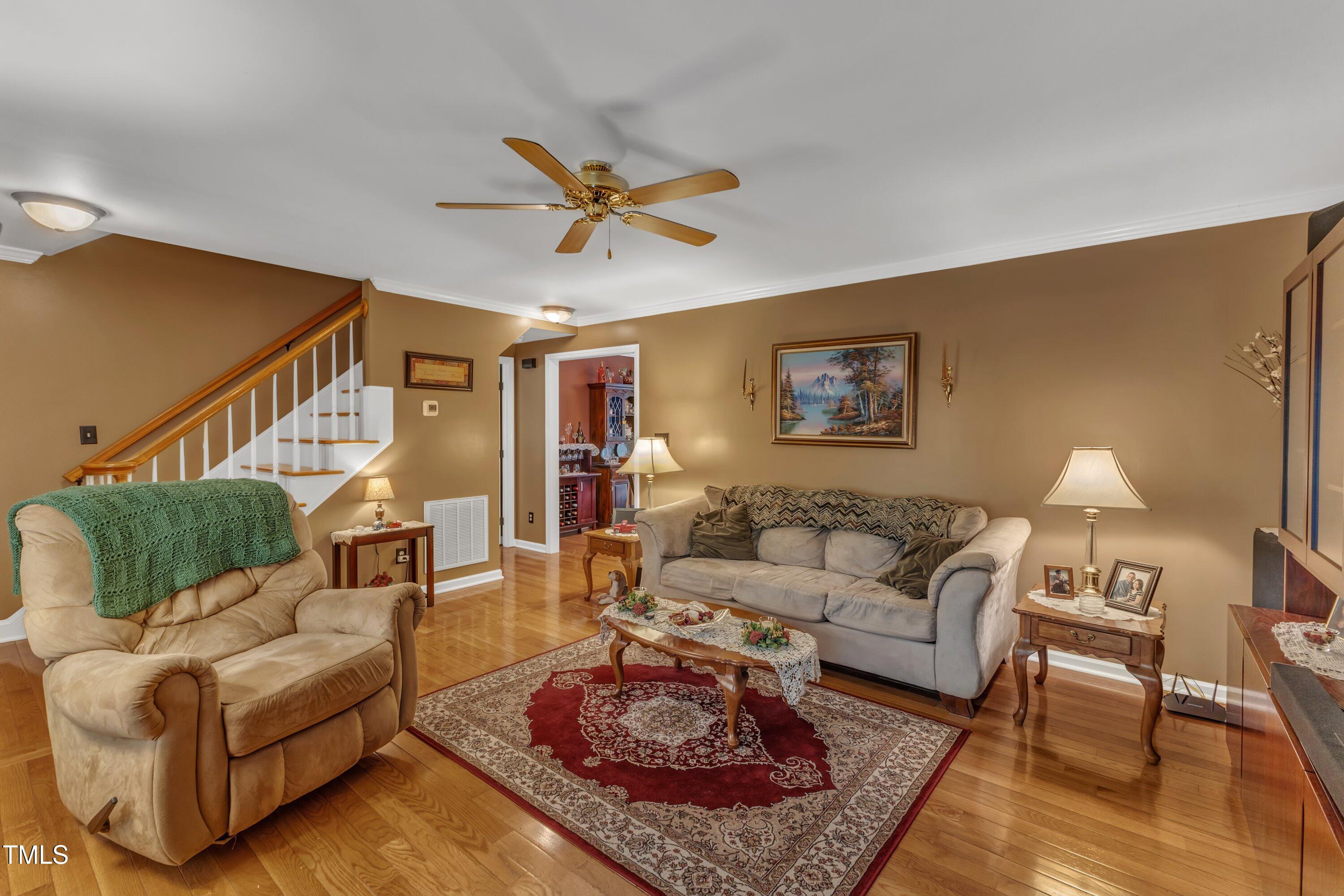 604 Young Forest Drive Wake Forest, NC 27587 - Photo 13 of 55 a living room with furniture a rug and a lamp