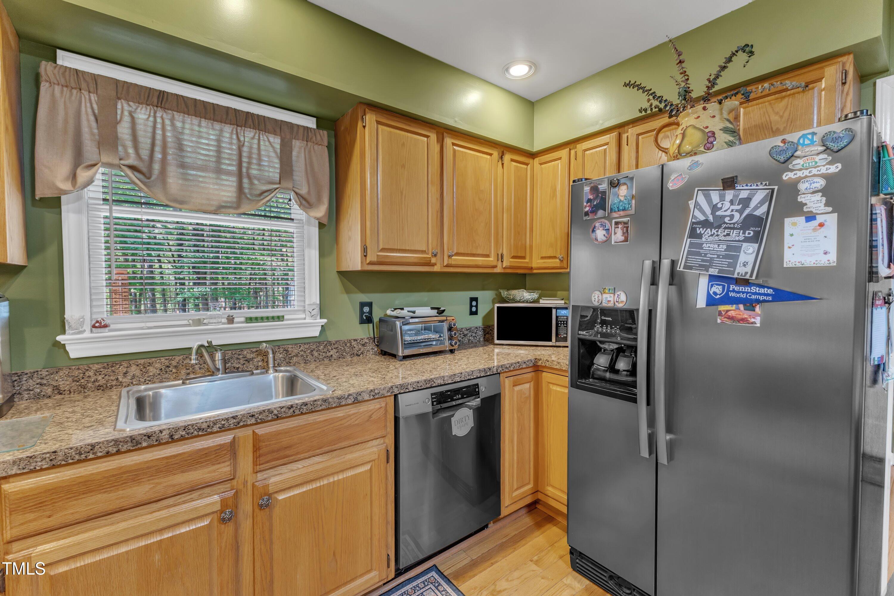 604 Young Forest Drive Wake Forest, NC 27587 - Photo 20 of 55 a kitchen with stainless steel appliances granite countertop a refrigerator and a sink