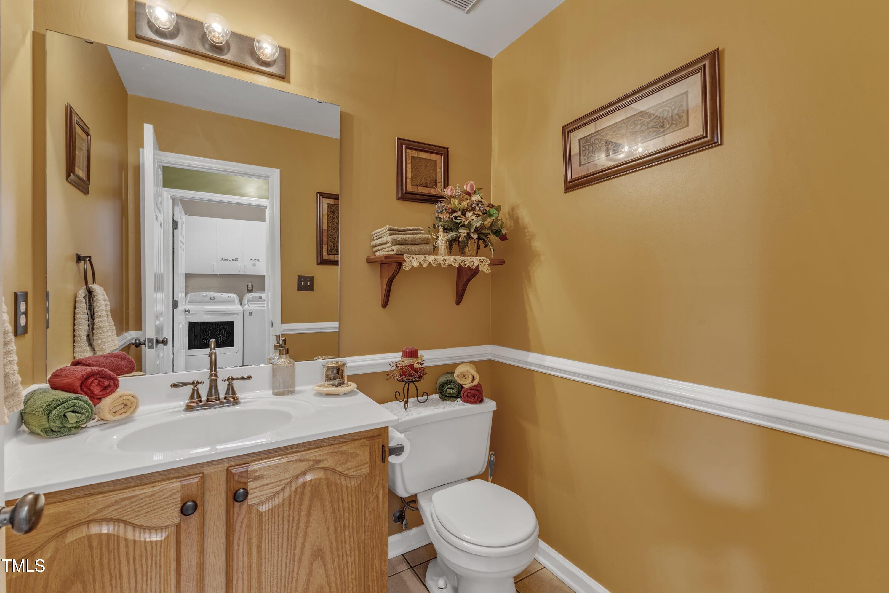 604 Young Forest Drive Wake Forest, NC 27587 - Photo 23 of 55 a bathroom with a sink mirror vanity and toilet