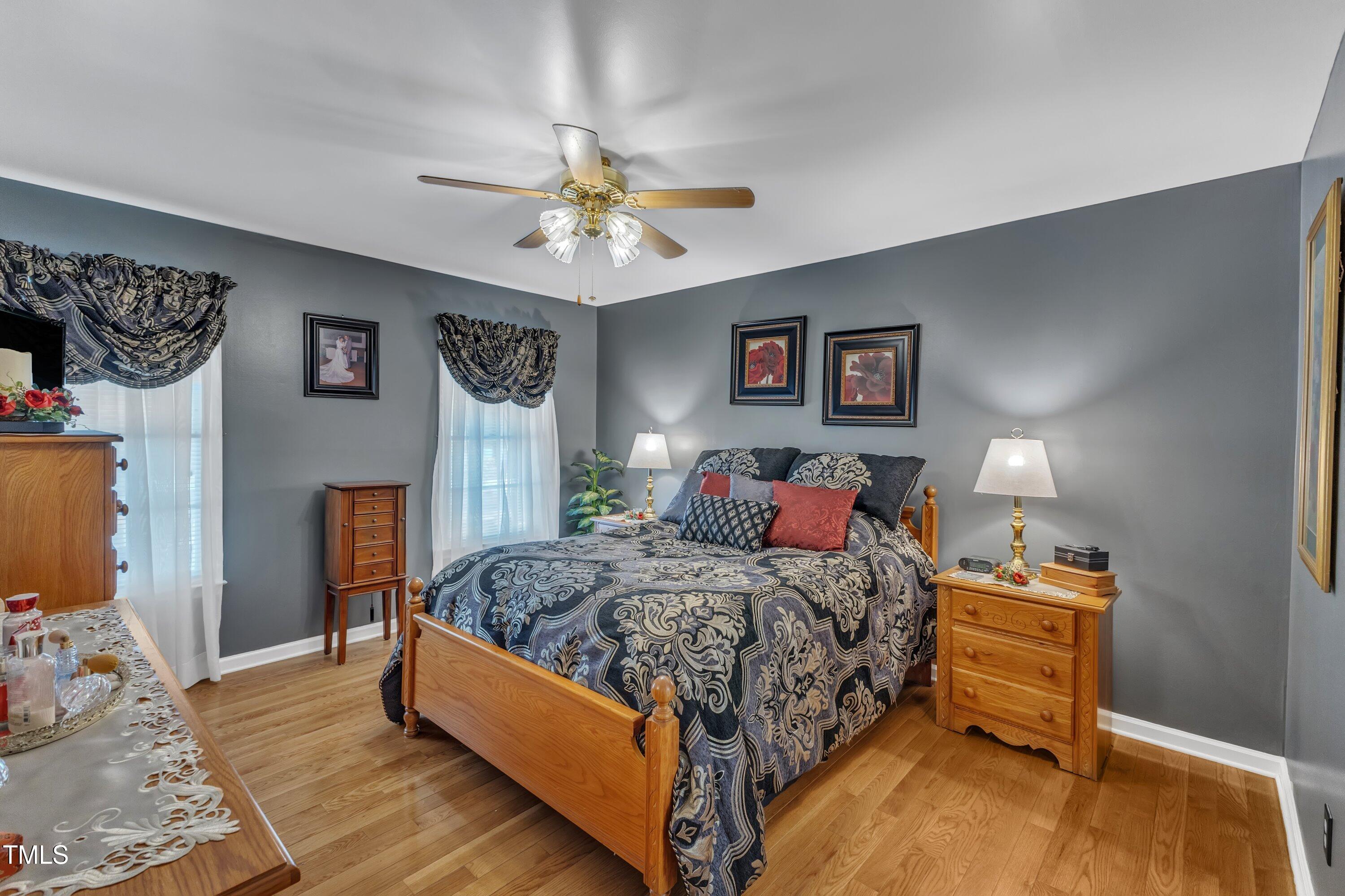 604 Young Forest Drive Wake Forest, NC 27587 - Photo 24 of 55 a bedroom with a bed and a chandelier