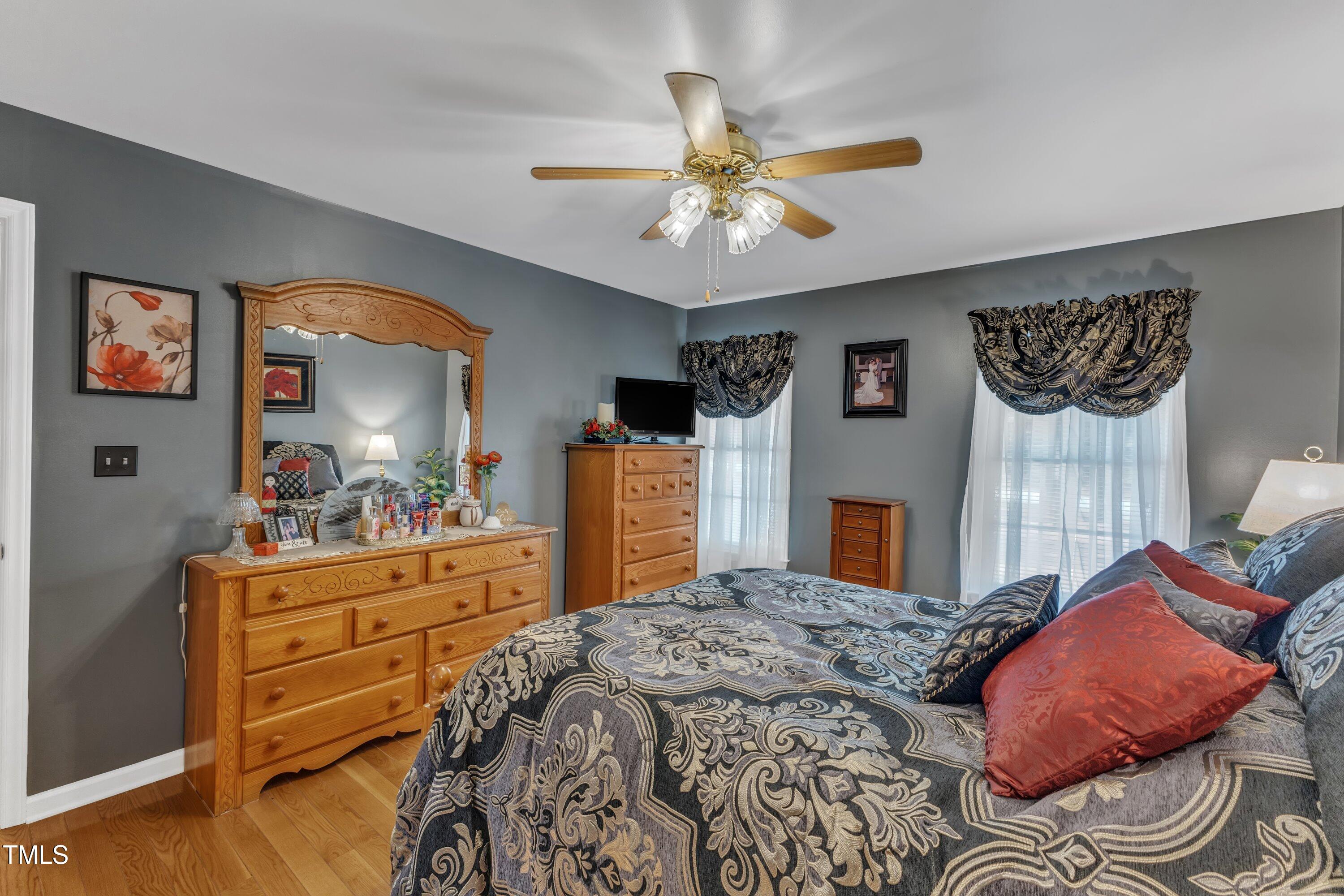 604 Young Forest Drive Wake Forest, NC 27587 - Photo 25 of 55 a bedroom with a bed and a chandelier