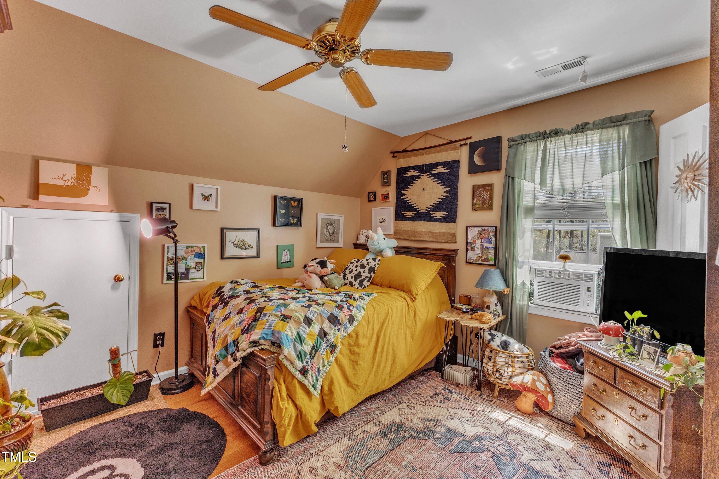 604 Young Forest Drive Wake Forest, NC 27587 - Photo 30 of 55 a bedroom with furniture and a flat screen tv