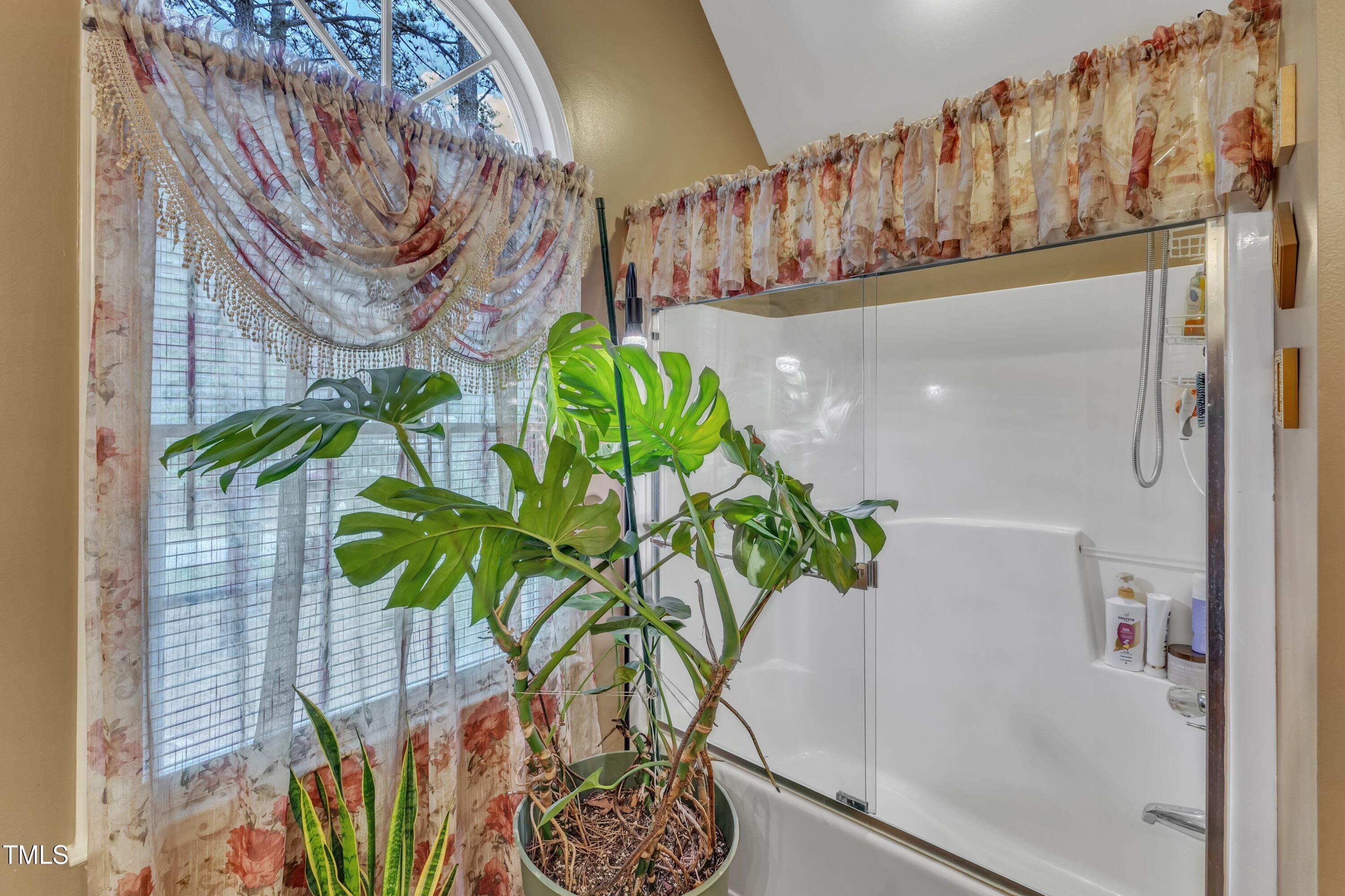 604 Young Forest Drive Wake Forest, NC 27587 - Photo 34 of 55 a vase of flowers sitting on a table with wooden floor