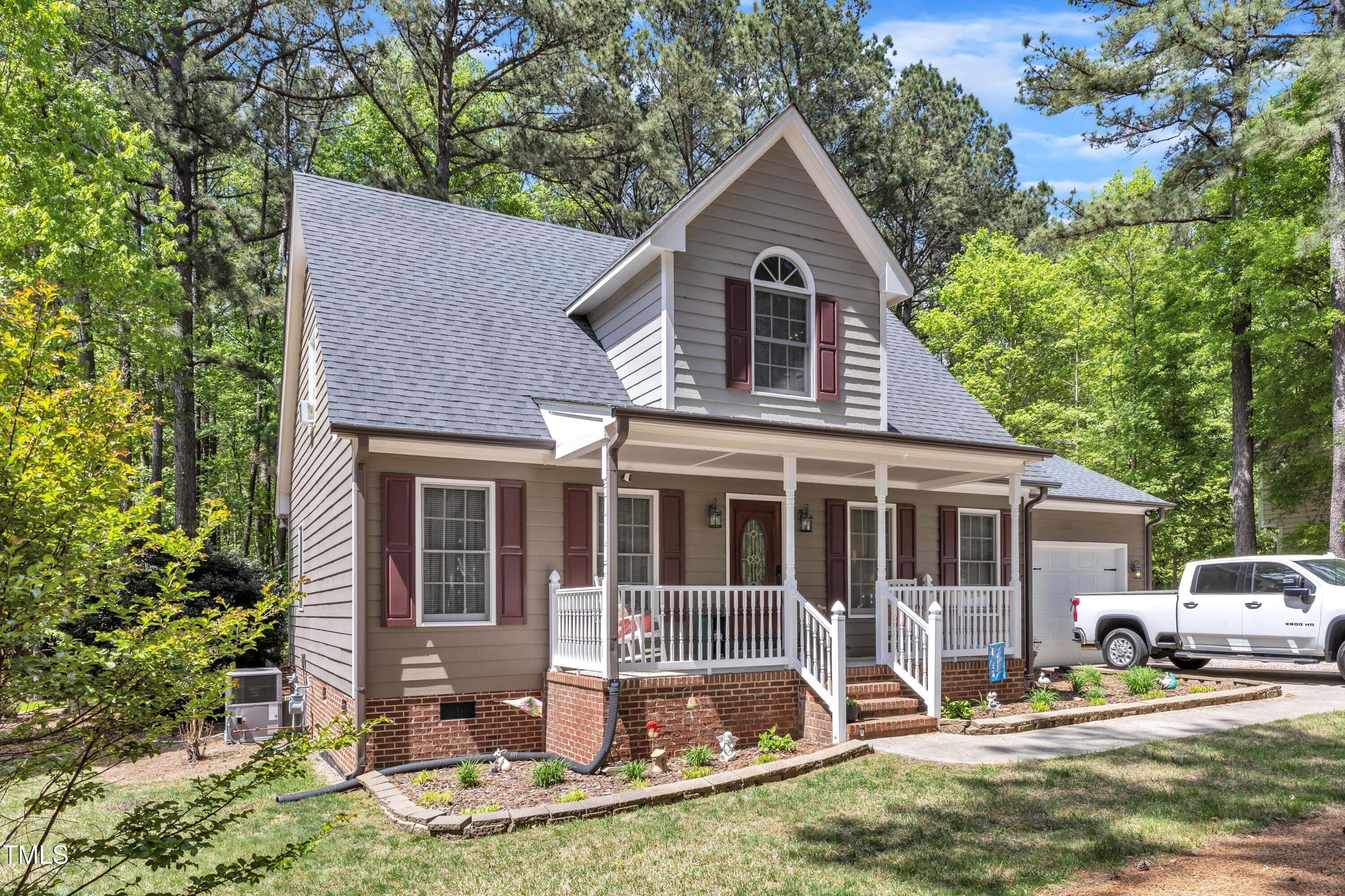 604 Young Forest Drive Wake Forest, NC 27587 - Photo 5 of 55 a front view of a house with a yard table and chairs