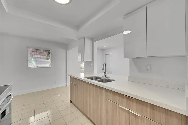 a kitchen with a sink and cabinets