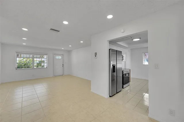 an empty room with windows and entrance