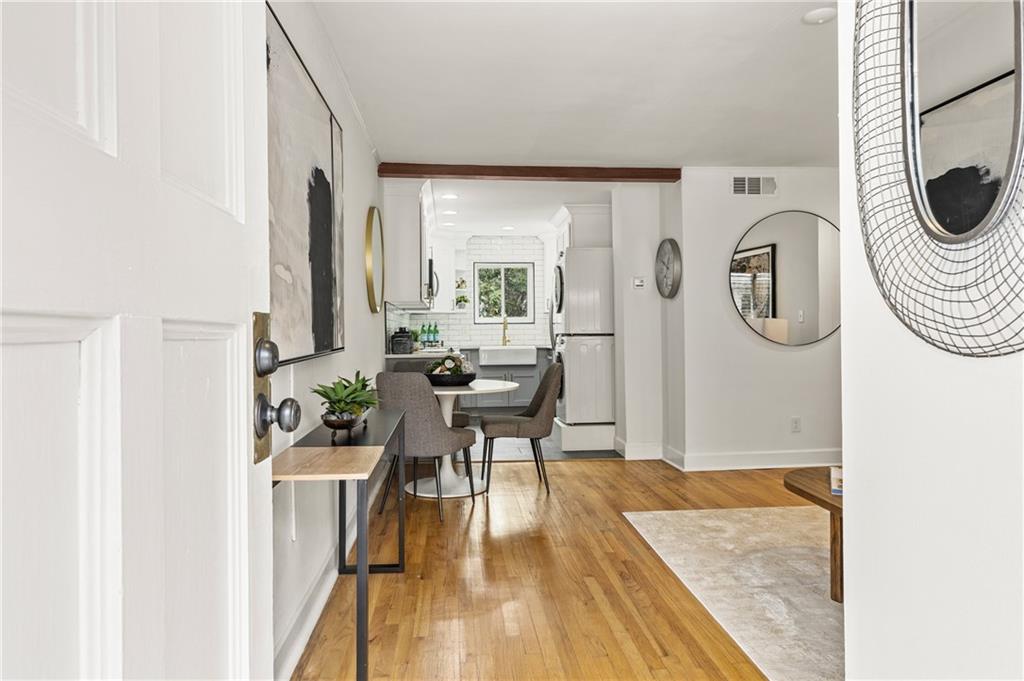 a living room with furniture a table and wooden floor