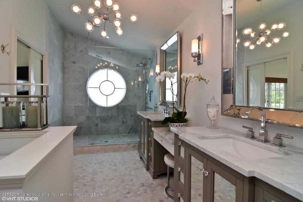 200 Colony Road Jupiter Inlet Colony, FL 33469 - Photo 14 of 26 a bathroom with a sink double vanity and a mirror