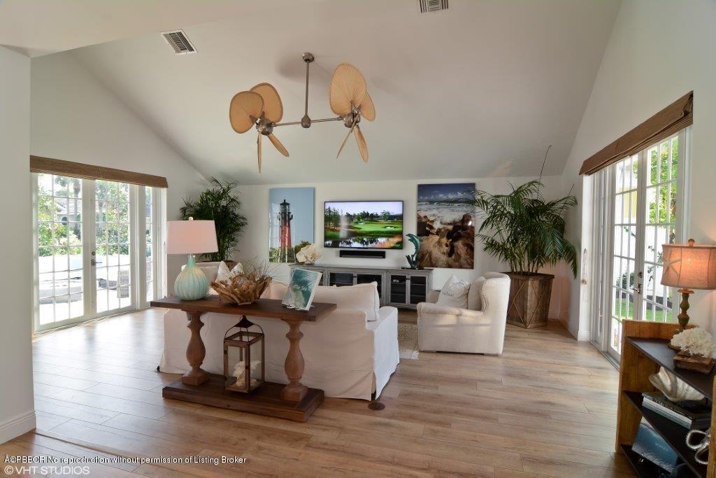 200 Colony Road Jupiter Inlet Colony, FL 33469 - Photo 7 of 26 a living room with fireplace furniture and a wooden floor