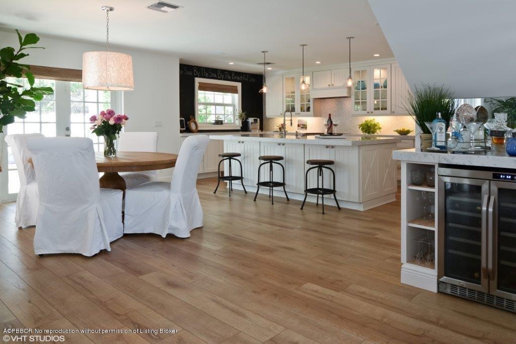 200 Colony Road Jupiter Inlet Colony, FL 33469 - Photo 9 of 26 a view of a dining room with furniture and wooden floor