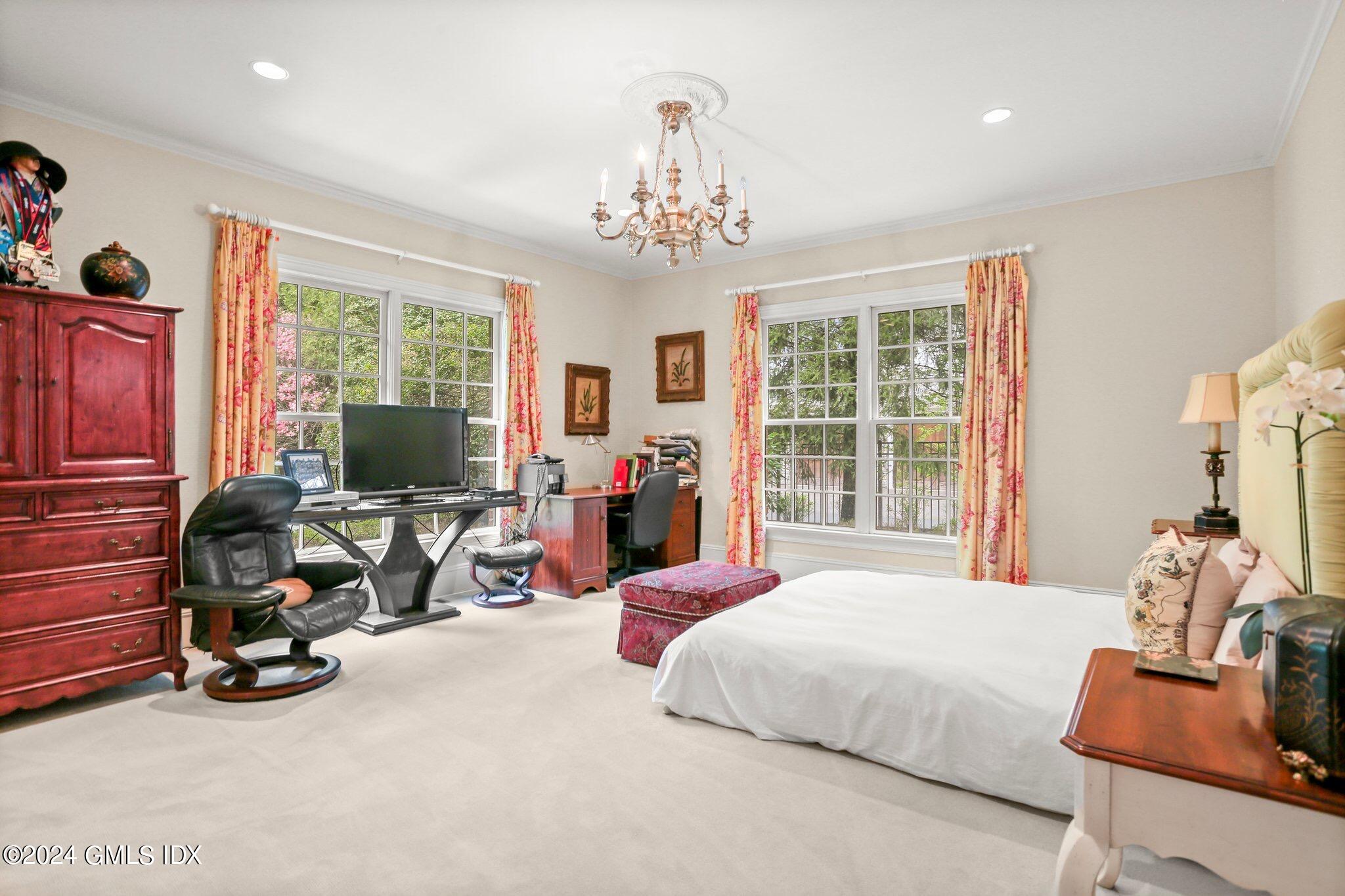 376 Westover Road Stamford, CT 06902 - Photo 9 of 37 a bedroom with furniture large windows and a chandelier