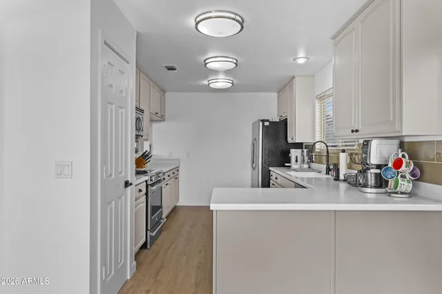 a kitchen with refrigerator and cabinets