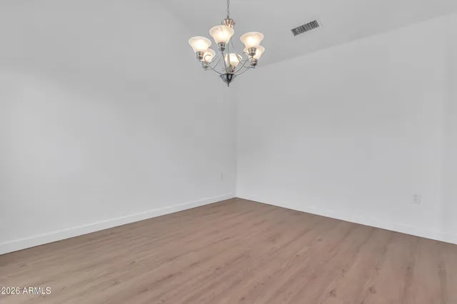 a view of a chandelier fan and wooden floor
