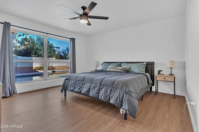 a bedroom with a large bed and a large window