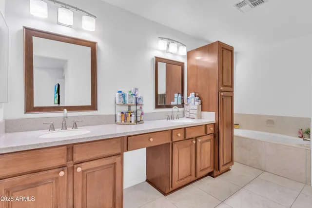 a bathroom with a tub sink and mirror