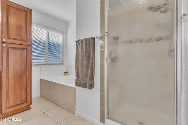 a bathroom with a shower and a glass door
