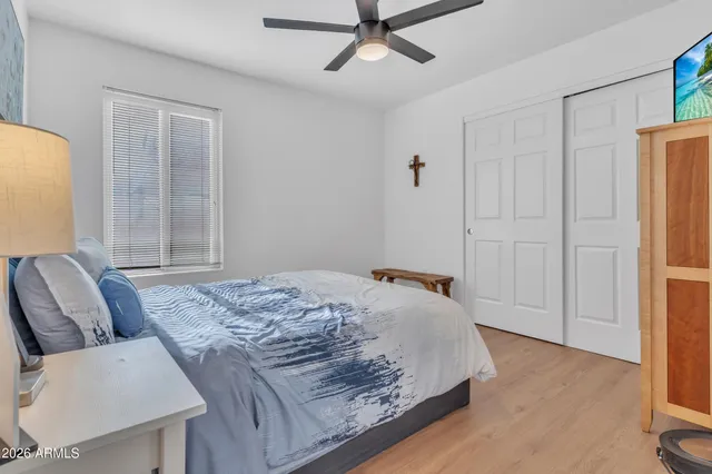 a bedroom with a bed and a chandelier
